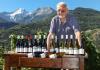The owner of Maison Anselmet with his wines and, in the background, the Grivola