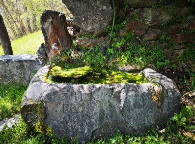 fountain carved into the rock  beyond the Marine village (Perloz)