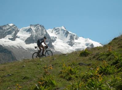 MTB ascent with Gran Paradiso in the background 